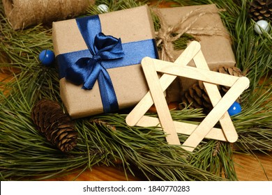Hanukkah. A gift, a symbol of Hanukkah. star of David. Around the fir branches and cones