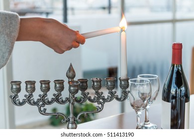 Hanukkah - Jewish Holiday Of Light With Menorah And Bottle Of Red Wine With Two Glasses By The Window