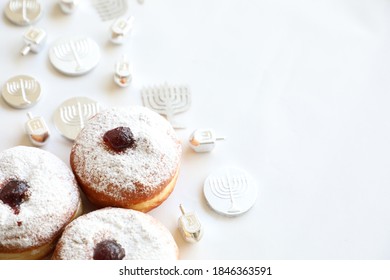 Hanukkah Table With Doughnuts And Dreidels In Silver