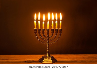 Hanukkiah, Hanukkah golden Menorah candelabra with burning candles on dark background, copy space. Celebration Hanukkah concept design.  Jewish Festival of Lights. - Powered by Shutterstock