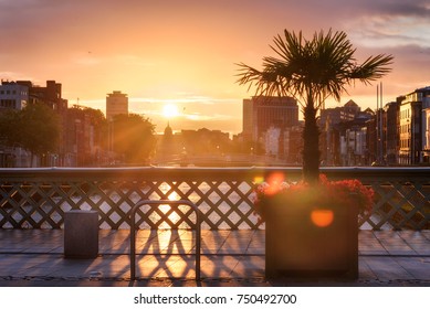 Hapenny Bridge Over River Liffey In Dublin At Sunset