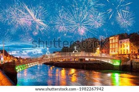 Ha'Penny Bridge at twilight blue hour with fireworks - Dublin, Ireland