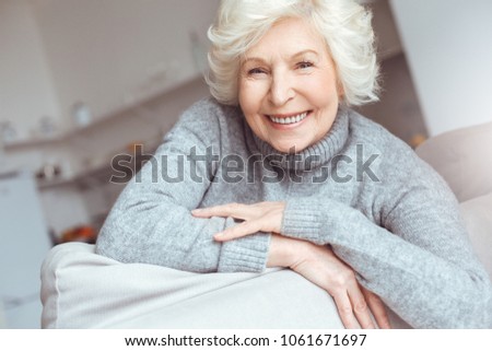 Hapiness old people concept. Portrait handsome grandmother in gray sweater.