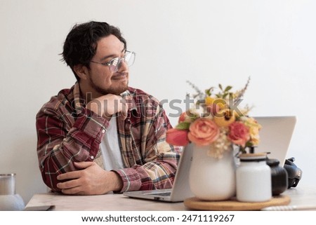 Happier man looking to the horizon while are using his laptot in the living room