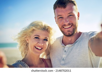 Happier Than A Seagull With A French Fry. Cropped Shot Of N Affectionate Couple Spending The Day At The Beach.