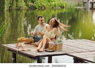 Happiest couple in love on picnic on summer day in beautiful place on wooden pier. Rest and enjoyment. Beautiful moments of life. Super day. Romantic relationships. Tenderness and care.  - Powered by Shutterstock