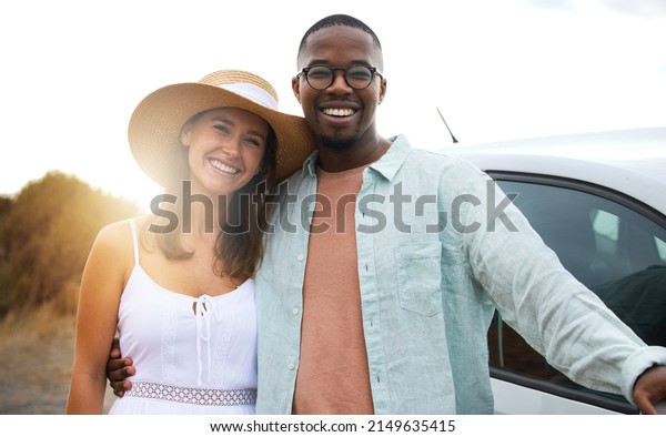 The happiest\
place on the earth is right here. Portrait of a happy young couple\
enjoying a romantic road\
trip.