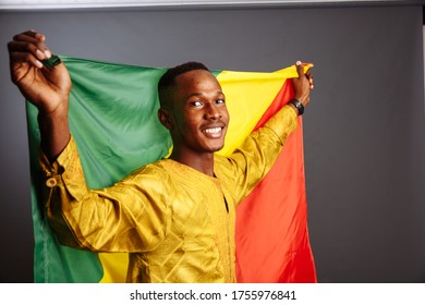 Happiness African Man In Traditional Clothes Dancing With Flag Of Congo, Isolated On Gray Background