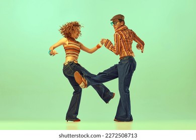 Happiness anf fun. Two excited people, man and woman in retro style clothes dancing disco dance over green background. 1970s, 1980s fashion, music, hippie lifestyle - Shutterstock ID 2272508713