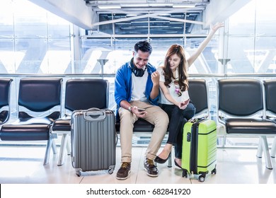 Happiness Asian Couple Traveler Holding The Passport With Suitcases In Modern An Airport, Travel And Transportation With Technology Concept.