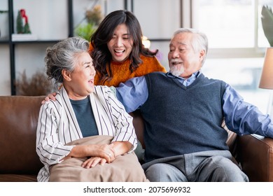 Happiness Asian Family Candid Of Daughter Hug Grandparent Mother Farther Senior Elder Cozy Relax On Sofa Couch Surprise Visiting In Living Room At Home,together Hug Cheerful Asian Family At Home