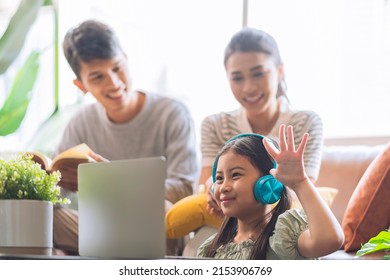 Happiness Asian Family Daughter Study Online From Home With Laptop While Father Mother Is Sitting Together Watch With Cheerful Smile ,asian Child Female Wear Headphone Answer Question From Teacher