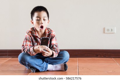 Happiness Asian Kid Playing On Smart Phone