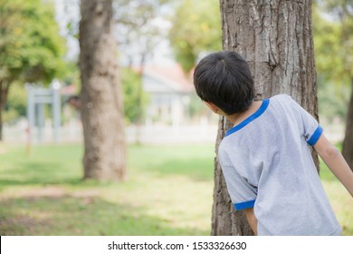 Happiness Of Asian Son And Father Playing Hide And Seek In The Garden During The Spring Holidays
