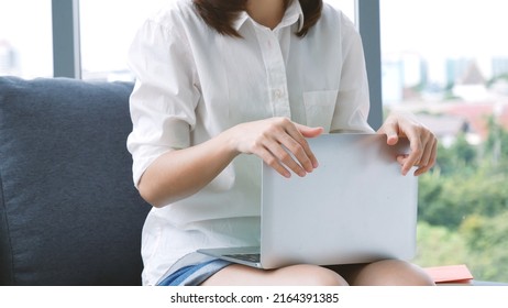 Happiness Asian Woman Working From Home Using Laptop Online Meeting In Home Office. Happy Relax Time Asian Business Woman Typing Keyboard Use Notebook Laptop Smiling, Laughing, Yawn At Home Office.