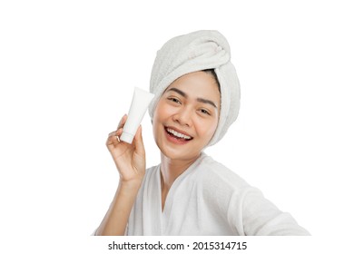 Happiness Beautiful Girl With Towel On Head Holding Tube Bottle Of Skin Care Products On Gray Background