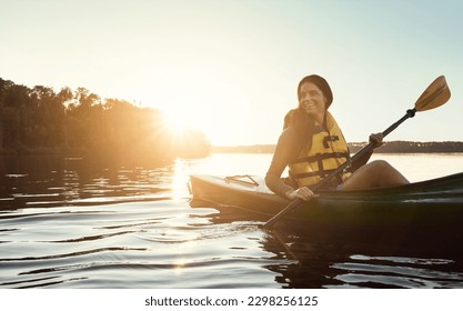 Happiness begins when you start kayaking. a beautiful young woman kayaking on a lake outdoors. - Shutterstock ID 2298256125