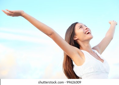 Happiness Bliss Freedom Concept. Woman Happy Smiling Joyful With Arms Up Dancing On Beach In Summer During Holidays Travel. Beautiful Young Cheerful Mixed Race Asian Chinese / Caucasian Female Model.