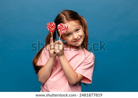 Similar – Image, Stock Photo Beautiful little girl, cute toddler with sunglasses is drinking orange juice and shows thumb up. Kid in in swimwear having fun during family vacation in a resort near pool. summer holidays