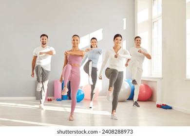 Happiness and collaboration as a group of sport people engages in a fitness session or exercise at the gym. The atmosphere is filled with smiles and positive energy, showcasing the teamwork. - Powered by Shutterstock