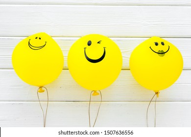 Happiness Emotion. Yellow Balloon With Smile On Blue Background Top View