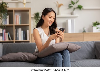Happiness Entrepreneur beautiful business asian young woman wear casual use mobile phone for shopping online enjoy with social media and laptop at home.Small Business Startup.online banking - Shutterstock ID 2103956774