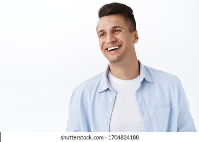 Happiness, Family And Emotions Concept. Close-up Portrait Of Handsome Happy Young Man With Stylish Haircut, Look Away Left Empty Space With Pleased Cheerful Smile, Laughing And Rejoicing