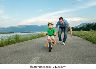 Happiness Father and son on the bicycle outdoor