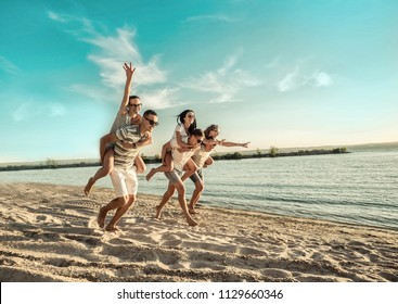 Happiness Friends fun on the beach under sunset sunlight in summer suny day. - Shutterstock ID 1129660346