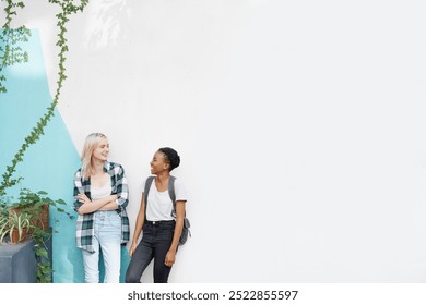 Happiness, girl and students on break with conversation for catch up, socializing and teenagers with mockup space. Female people or friends, communication and university for education and talking. - Powered by Shutterstock