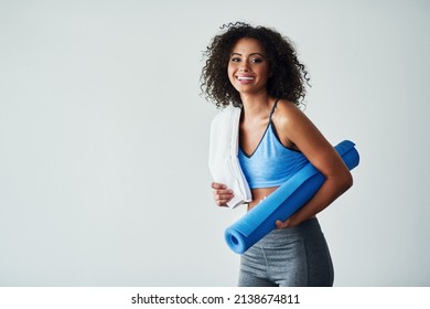 Happiness And Healthiness Is Becoming The Better Version Of Yourself. Studio Shot Of An Athletic Young Woman Against A Grey Background.