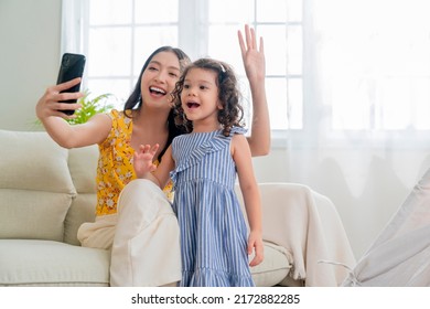 Happiness Lifestyle At Home ,asian Female Woman Nanny Aupair Takecare Playing Smartphone Selfie With Little Child Girl With Cheerful Laugh Smiling In Living Area At Home Morning Weekend Peaceful