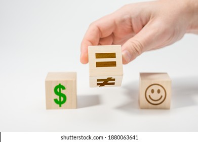 Happiness Or Money As A Choice In Life. Hand Flip Wooden Cube With Symbol Unequal Change To Equal Sign. White Background. Equality Concept On Wooden Cubes. Money Cannot Buy You Happiness