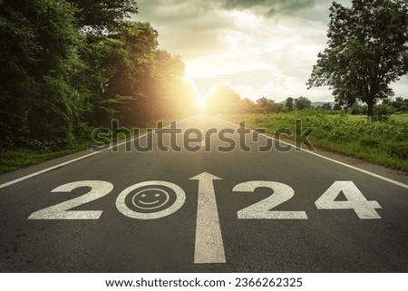 Happiness in New Year 2024 or straightforward concept. Text 2024 and smiley face written on the road in the middle of asphalt road at sunset. Happiness, optimistic, challenge, hope, new life change.