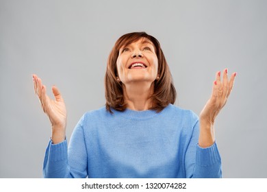 Happiness And Old People Concept - Portrait Of Smiling Senior Woman Looking Up Over Grey Background