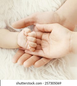 Happiness parents! closeup hand baby in hands mother and father
