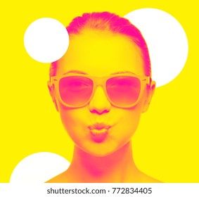 happiness and people concept - portrait of teenage girl in pink sunglasses blowing kiss, trendy duotone effect