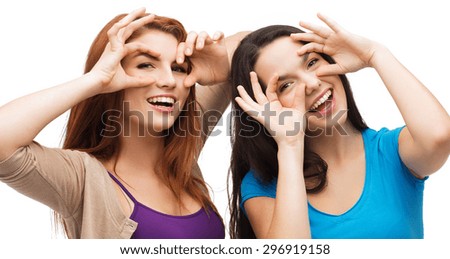 happiness and people concept - two young teenagers making funny faces