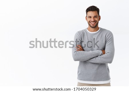 Happiness, people and men health concept. Attractive smiling caucasian guy with beard, wear grey sweater, cross arms chest in casual pose, laughing and gazing camera enthusiastic, chatting