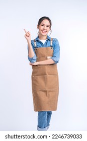 happiness smiling asian young adult female woman wearing apron uniform hand gesture finger point up ,young asia woman barista look at camera studio shot on white background - Shutterstock ID 2246739033