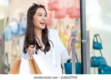 Happiness Smiling Young Happy Beautiful Asia Woman Holding Colorful Shopping Bags While Open The Shopping Mall Glass Entrance Door Shopfront Store,Woman Leaving A Store With Shopping Bags