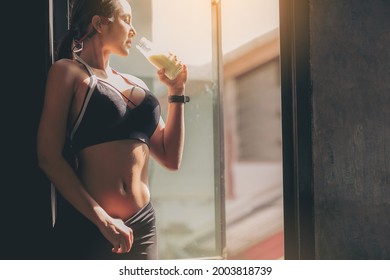 Happiness Woman In Sportswear Drinking Protein Powder Milkshake After Workout At Fitness Gym.