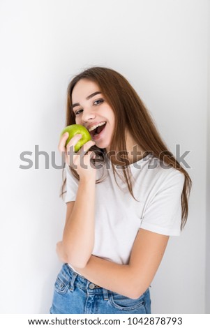 Happu hungry beautiful girl eating apple at home