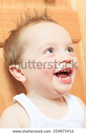 Similar – Happy adorable infant baby boy child smiling while eating two frozen fruit popsicle ice creams in simmer.