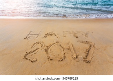 Happy 2017 written on seashore sand , Concept for upcoming new year 2017 .