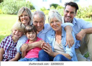 Happy 3 generation family in grandparents' backyard - Powered by Shutterstock