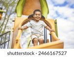 A Happy 3 years old boy on a swing. Happy kid on playground