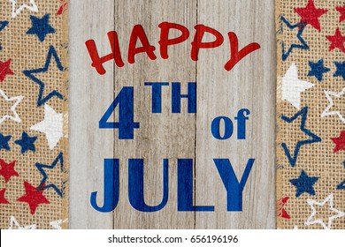 Happy 4th Of July Text With USA Red, White And Blue Stars Burlap Ribbon On Weathered Wood