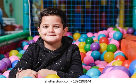 Happy 5 Year Old Boy With Mask In A Ball Pool So Happy