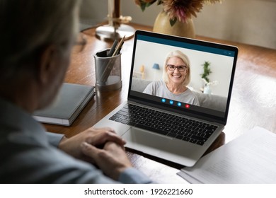 Happy 50s Years Old Couple Chatting Via Video Call From Home. Laptop Screen View Of Middle Aged Woman Talking To Husband Or Father. Family Speaking At Webcam During Remote Virtual Conference Meeting